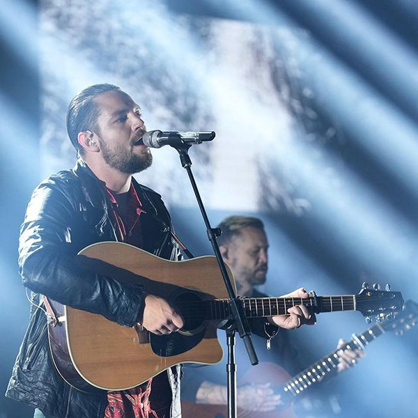 Chayce playing guitar on stage